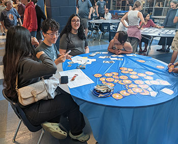 Mu Alpha Theta students host a game table.