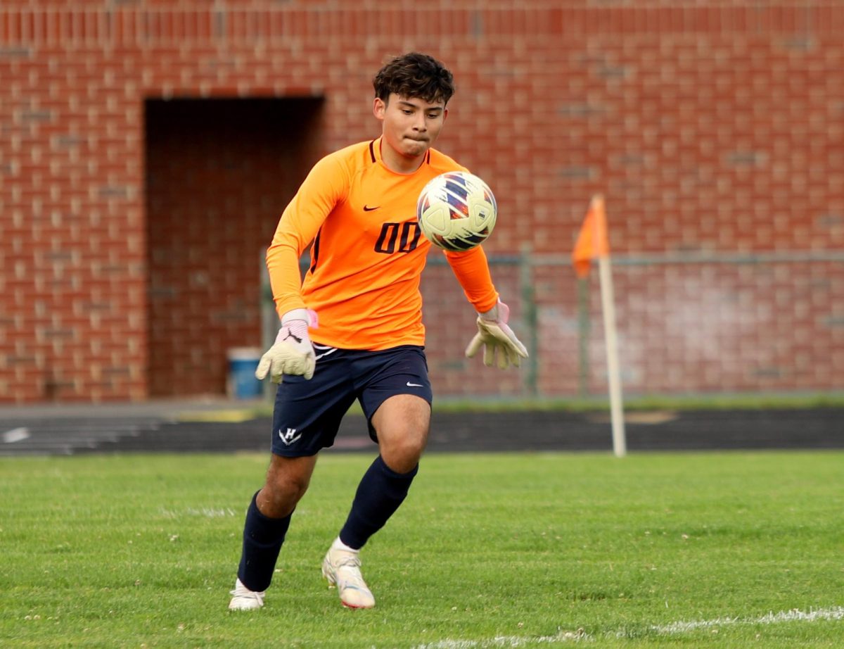 Senior Adolfo Rivera Rivas kicking the ball to his teammates 