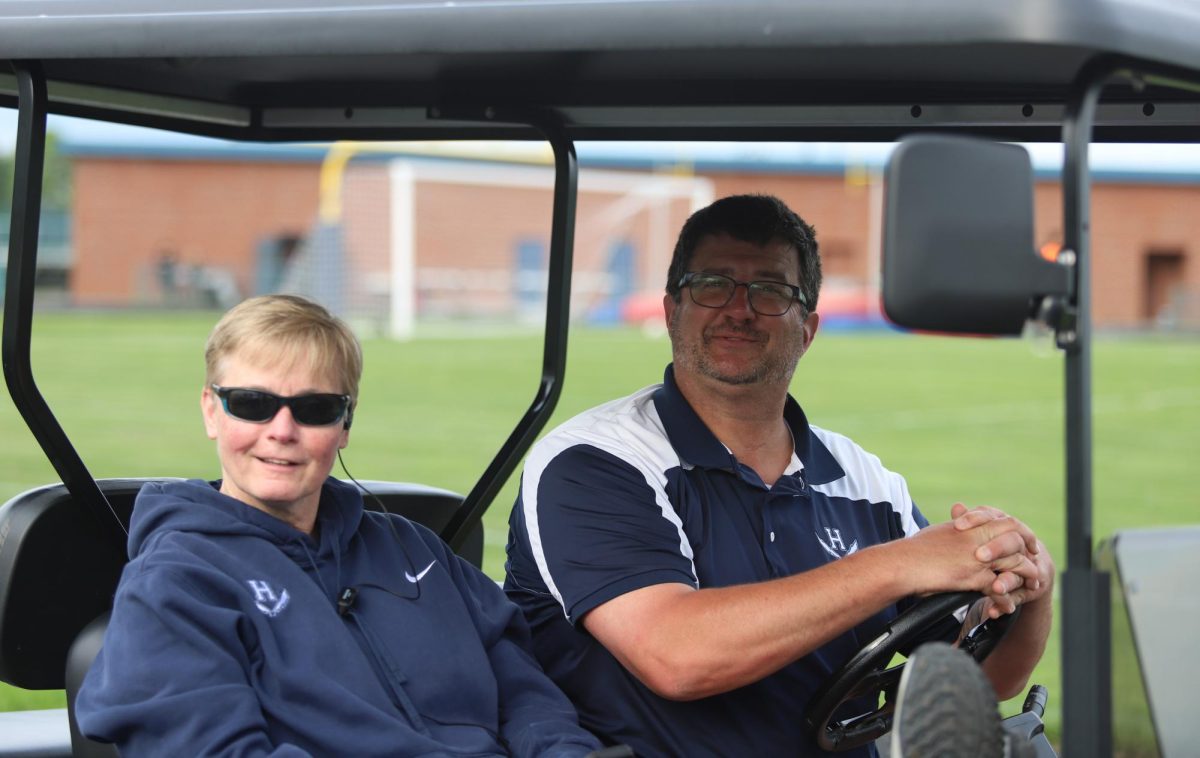 Principle Hensly and administrator Berly smiling for the camera