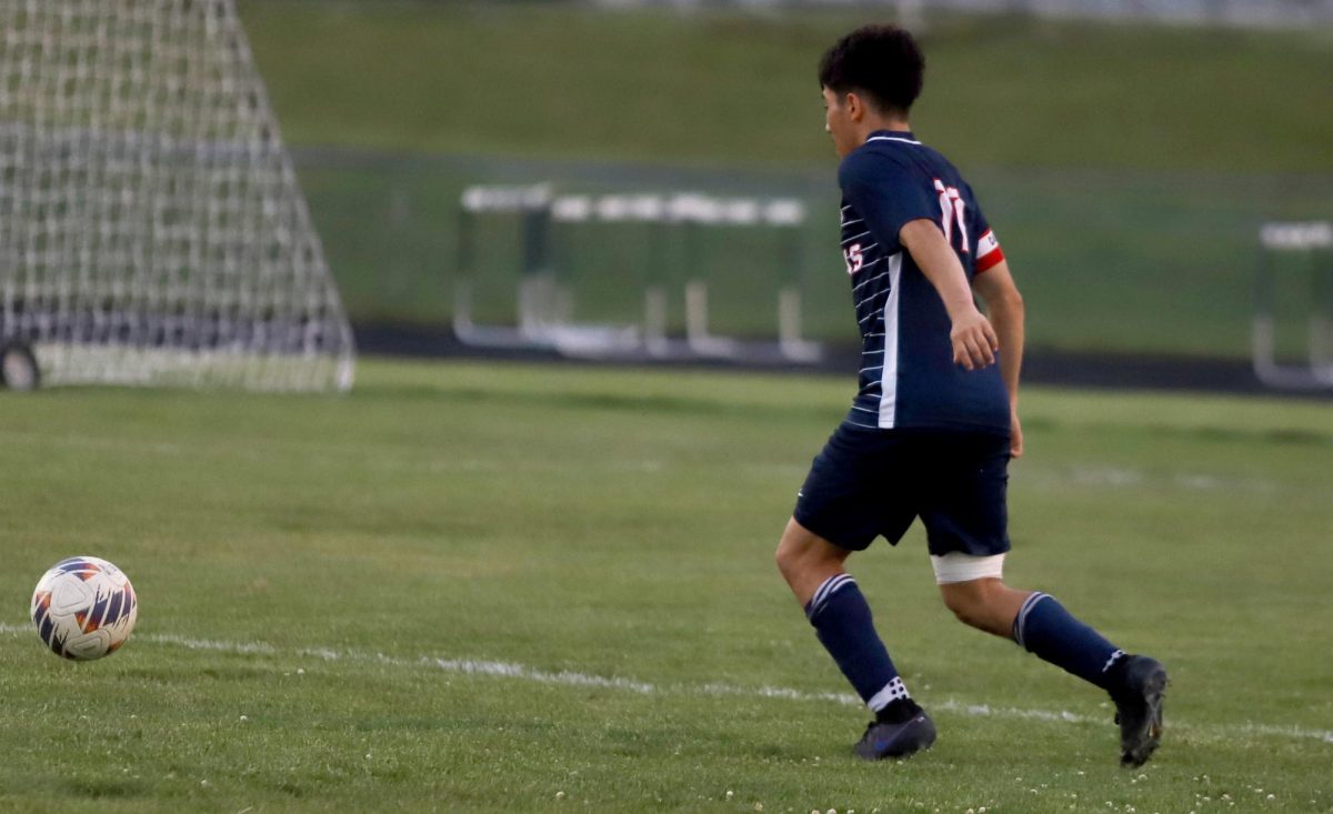 Senior Izaack Gonzalez about to kick the ball.