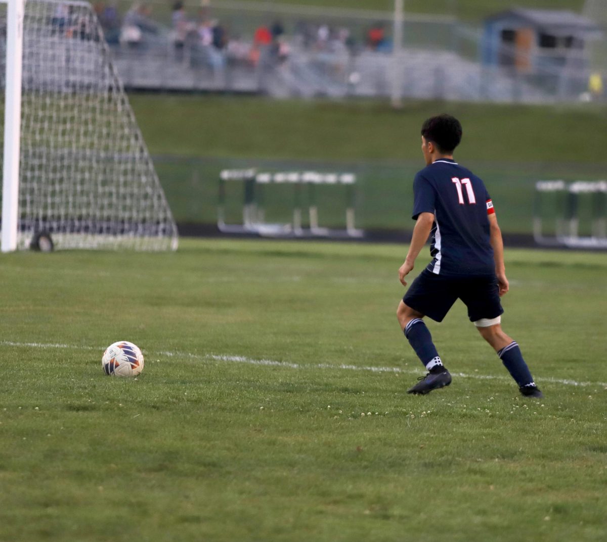 Senior Izaack Gonzalez kicking the ball.