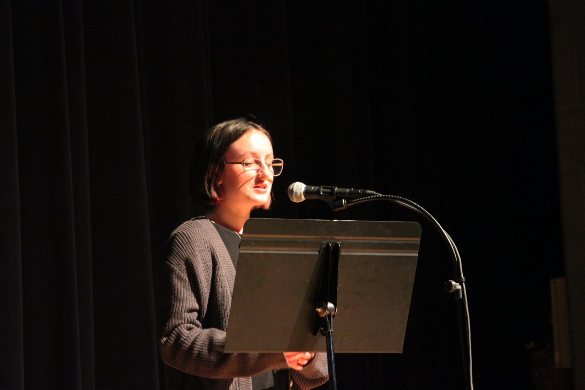 Senior Jillian Pyle reads her poem to the audience