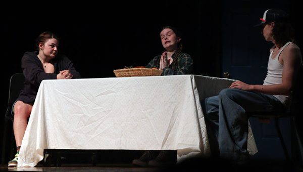 May, played by Reese Tibbles, attempts to say a prayer at the table.
