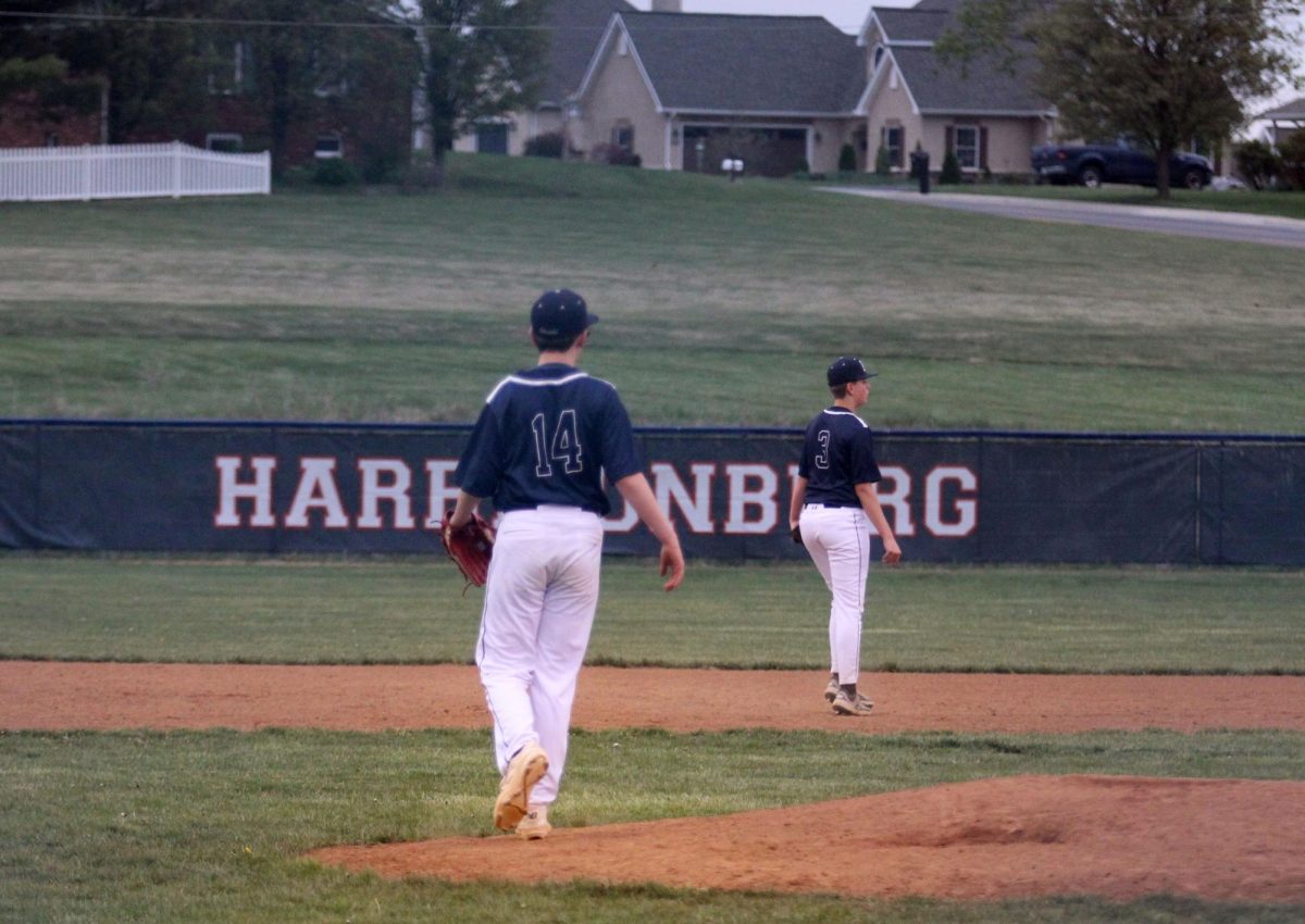 JV baseball players get in their positions.