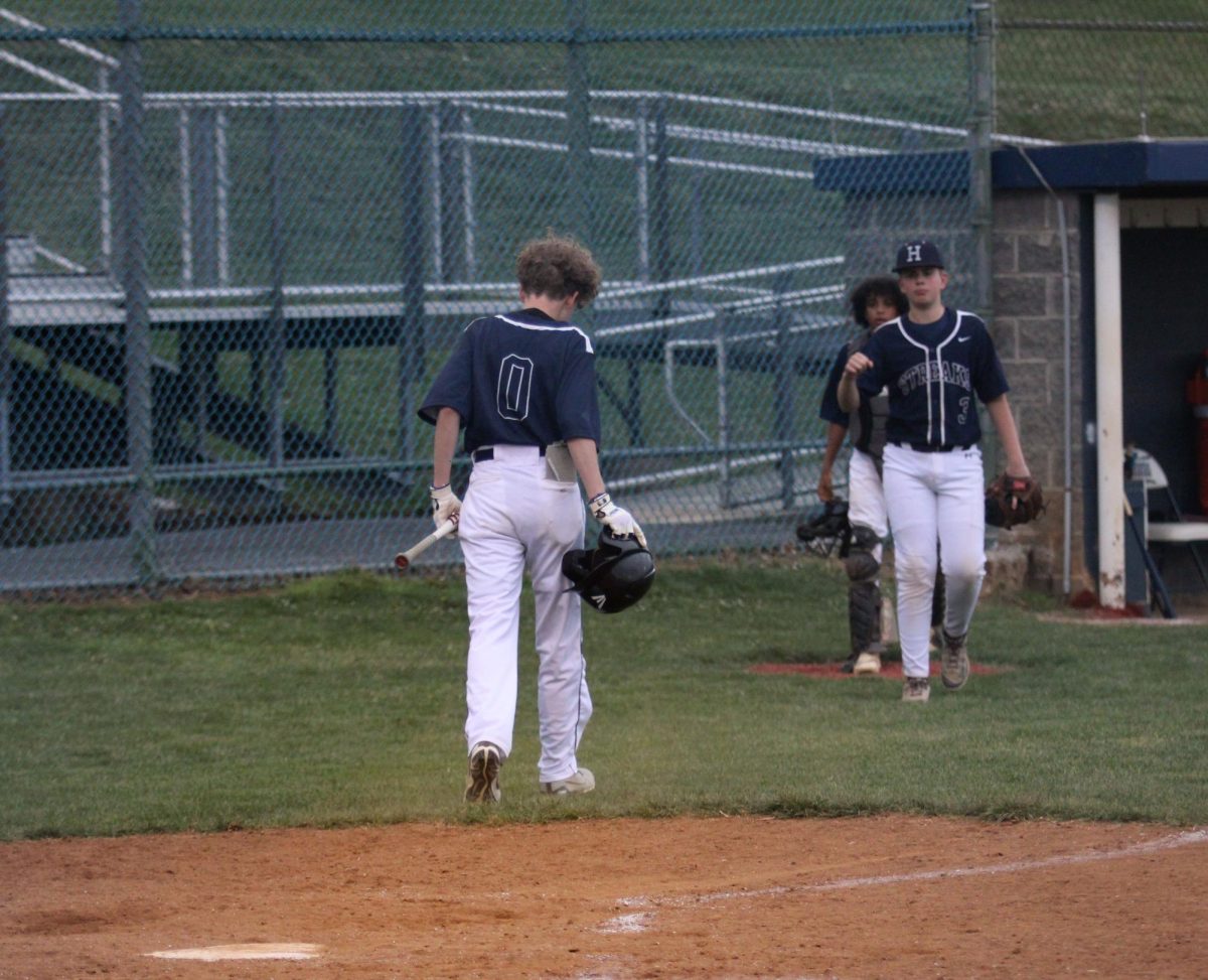 JV baseball players switch off the field.