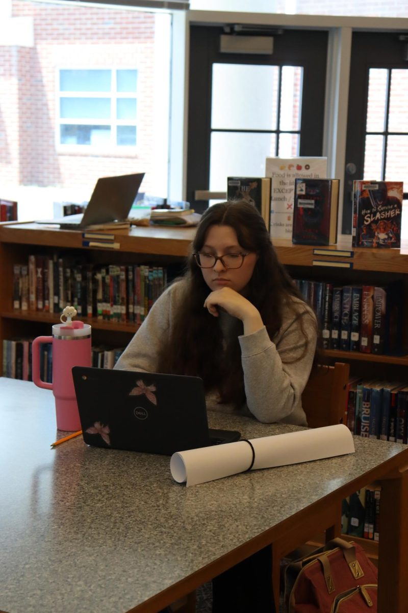Student working hard on her chromebook. 