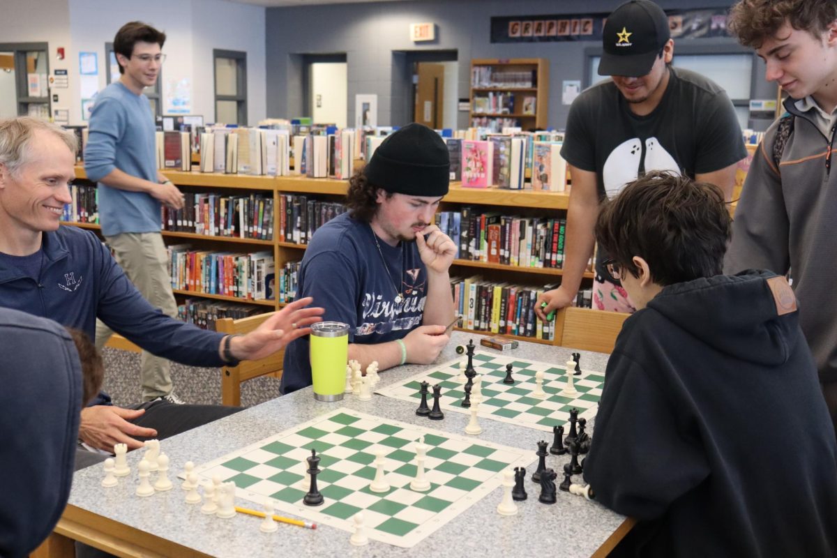 Students playing chess and thinking about their next move. 