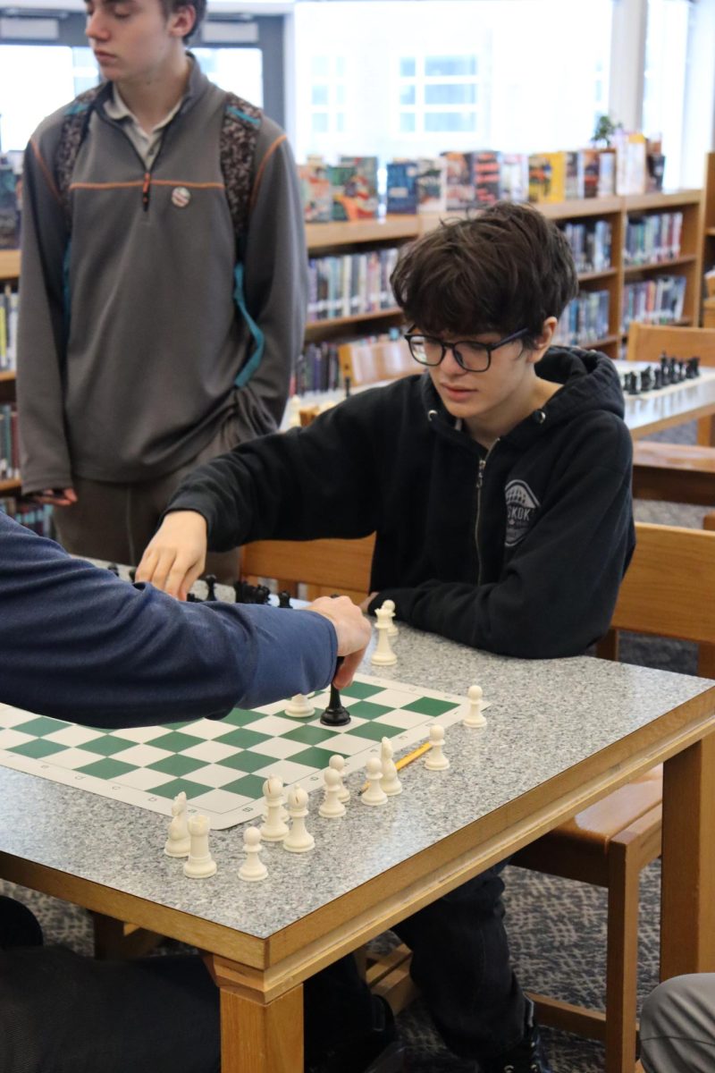 Student moving his pawn to his next spot. 