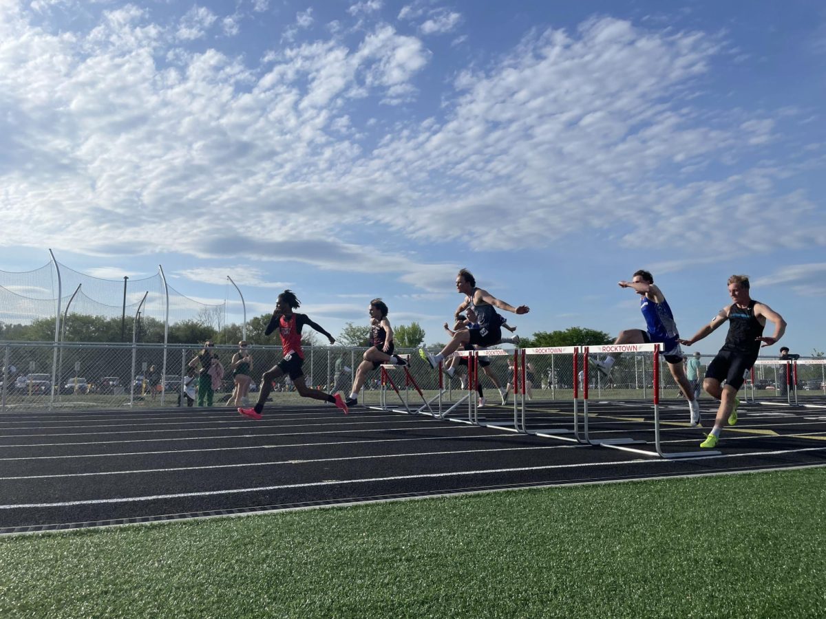 Senior Lucas Swartz runs with hurdles. 