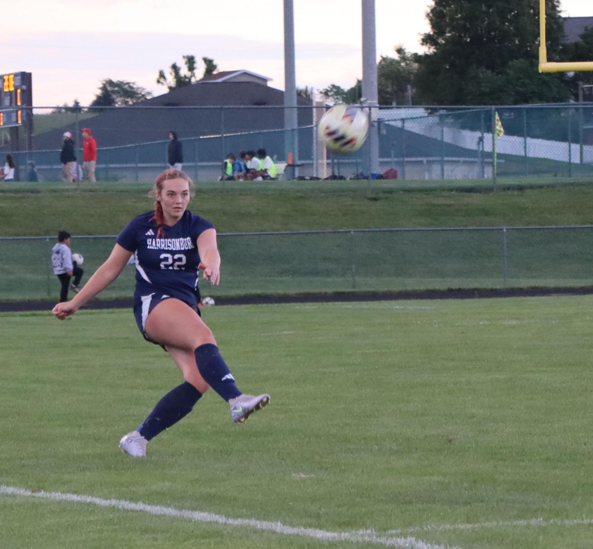 Junior Molly Ludwig kicking ball during a free kick