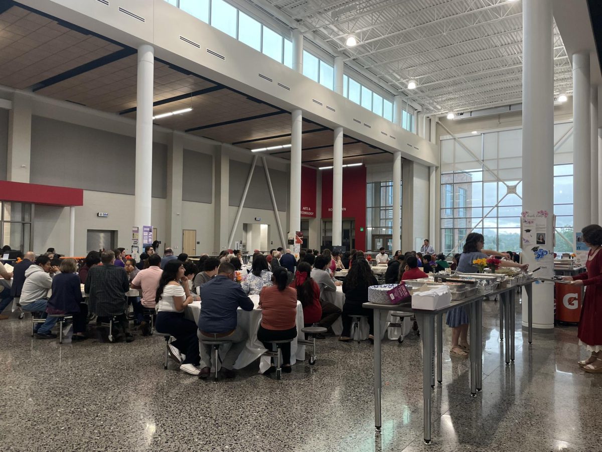 People who attended the AVID banquet for seniors listen to an announcement. 
