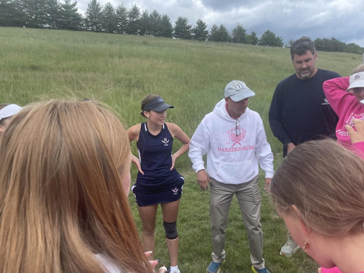 Tennis Coach Lawson Yoder gives tennis players a pep talk. 