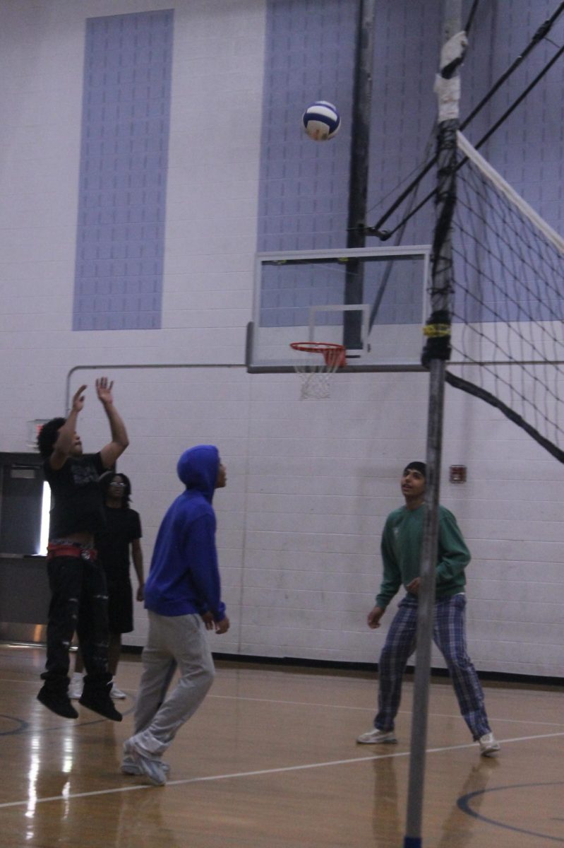  Angel Andujar is hitting the ball high over the net.