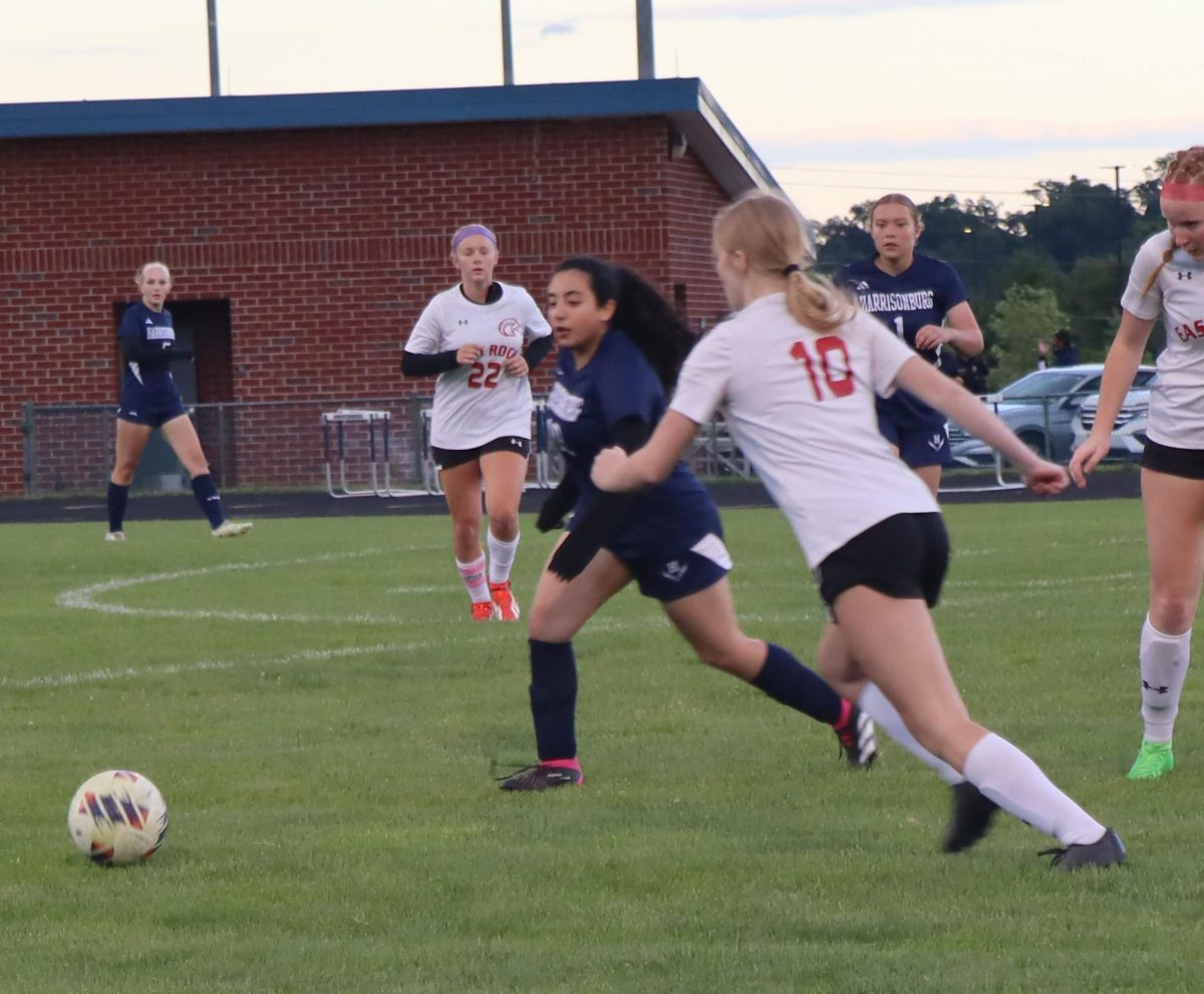 Junior Sara Hussein outrunning rival player for the ball