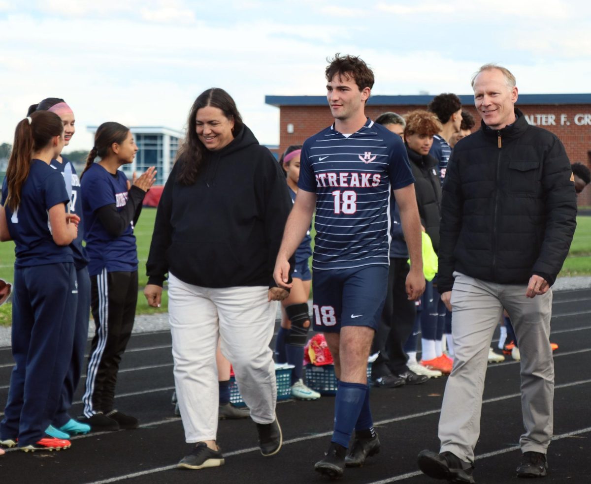 Senior Arlo Von Rotz and his parents participate in senior night.