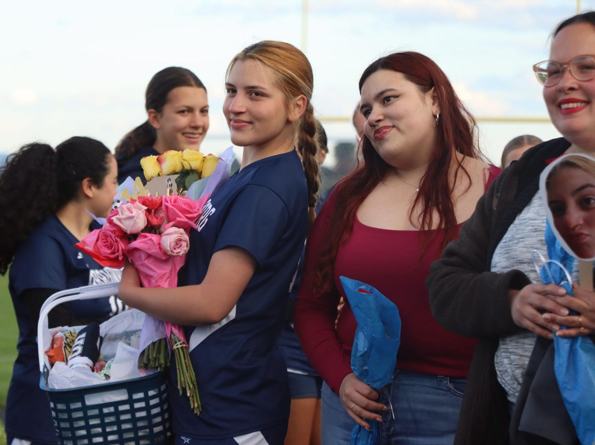 Senior Michelle Segarra and her family participate in senior night.