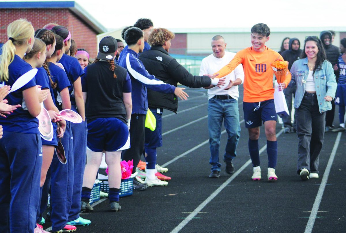 Senior Adolfojose Rivera Rivas is walked out by family members on senior night to be honored.