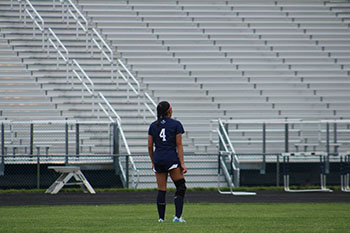 Varsity soccer player waiting for the ball to get back to the field.