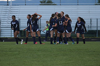 Girls varsity soccer celebrating as they make a goal leading to their win against East rock high.