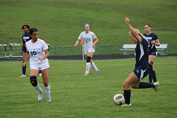 HHS varsity soccer player Katie Grace kicks the ball to make a goal.