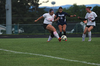 Senior varsity soccer player Leeanne Lara Irias tries to take the ball from her opponents.