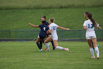 HHS team players fight to get the ball from the broadway opponent.