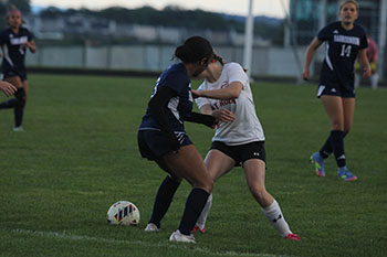 HHS varsity player Linda Hamilton tries to take East Rock's high opponents ball.