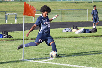 Senior Temesgen Habtemichael shooting the ball to his teammates to score a goal.
