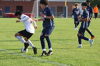 Senior Juan Chirinos trying to take the ball away from East Rock opponent.