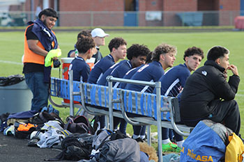 HHS varsity team players in the bench during soccer match against East Rock High School.