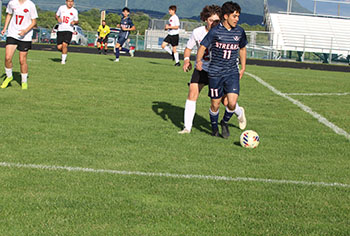 Senior Izaack Cruz has control of the ball trying to pass it to his teammates.
