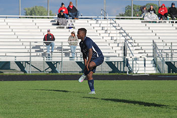 varsity soccer player waiting for his teammates to pass the ball.