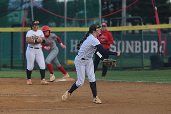 Varsity player #5 throws the ball to the opponent's batter.