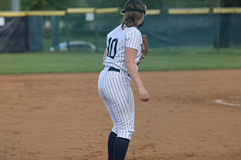 Varsity softball player #10 waiting for the ball.