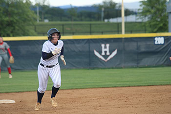 Varsity softball sophomore Jordyn Byler sprinting to the third base.