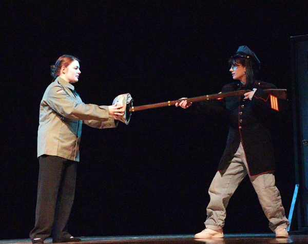 A soldier played by Hazel Pinnow tries to talk out a conflict with another soldier, played by Lila Hostetler.