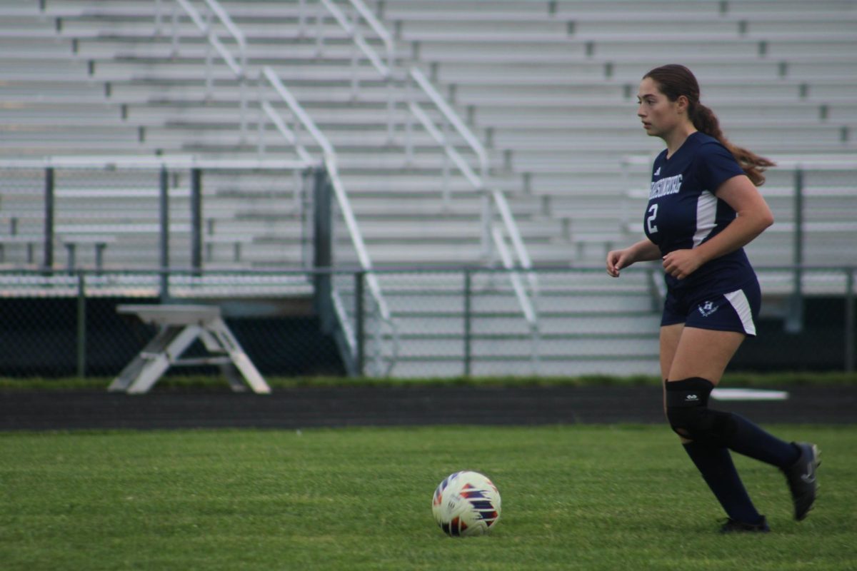 HHS girls varsity soccer team player #2 chasing after the ball.