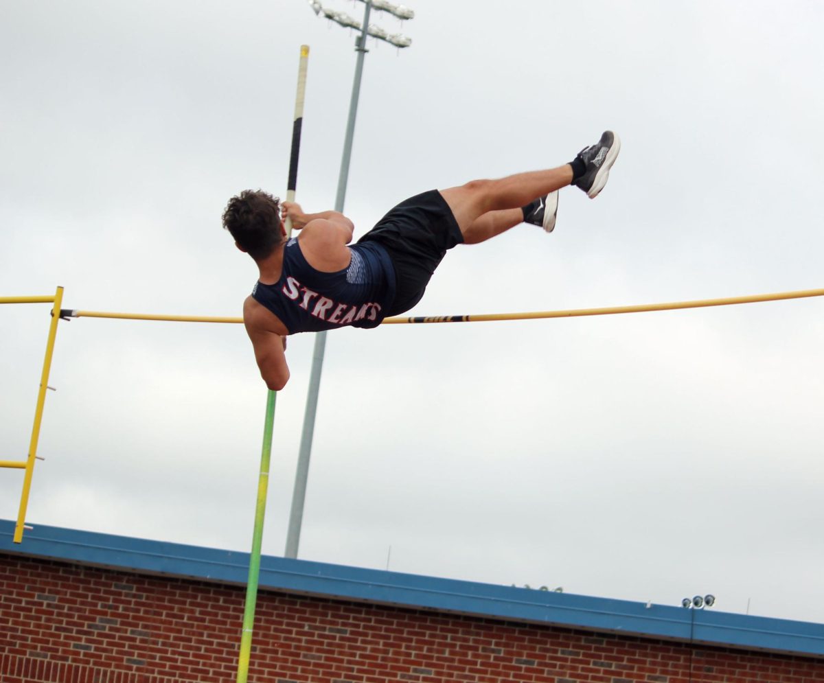 Nolan Beach swinging over the bar.
