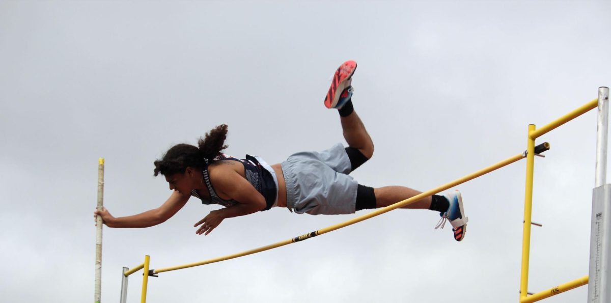 Dominic Rodriguez using his pole to push over the bar.