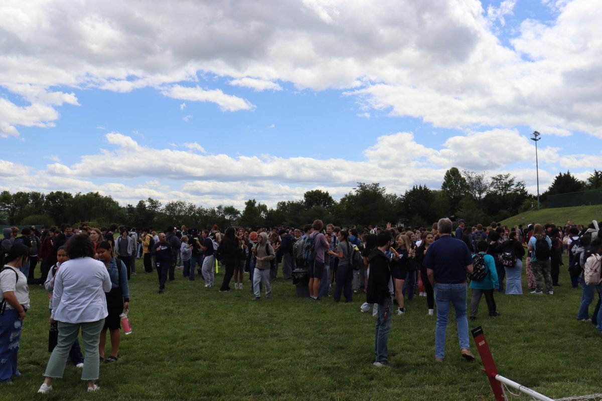 Students mingle while eating popsicles.