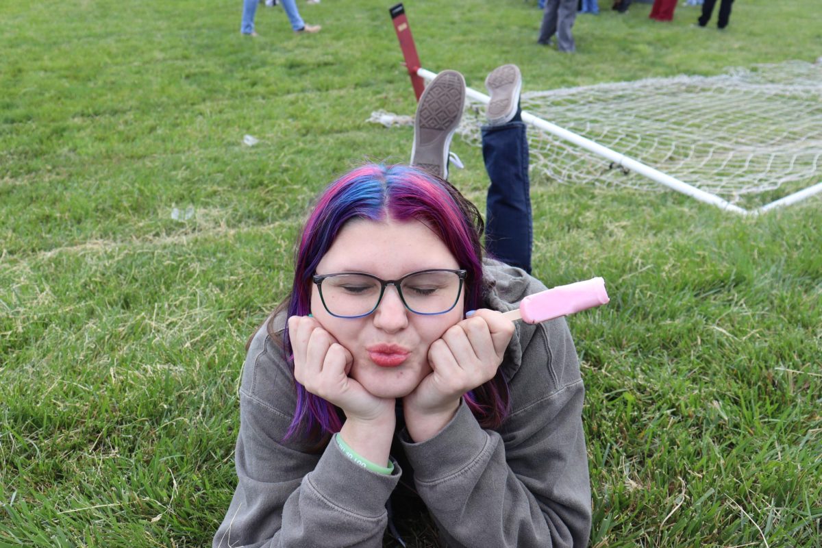 Junior Keira Miller poses in front of the camera, making duck lips as her popsicle slowly melts.