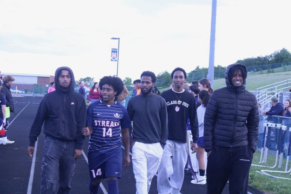 Senior Temesgen Habtemichael walks down the track to receive recognition.