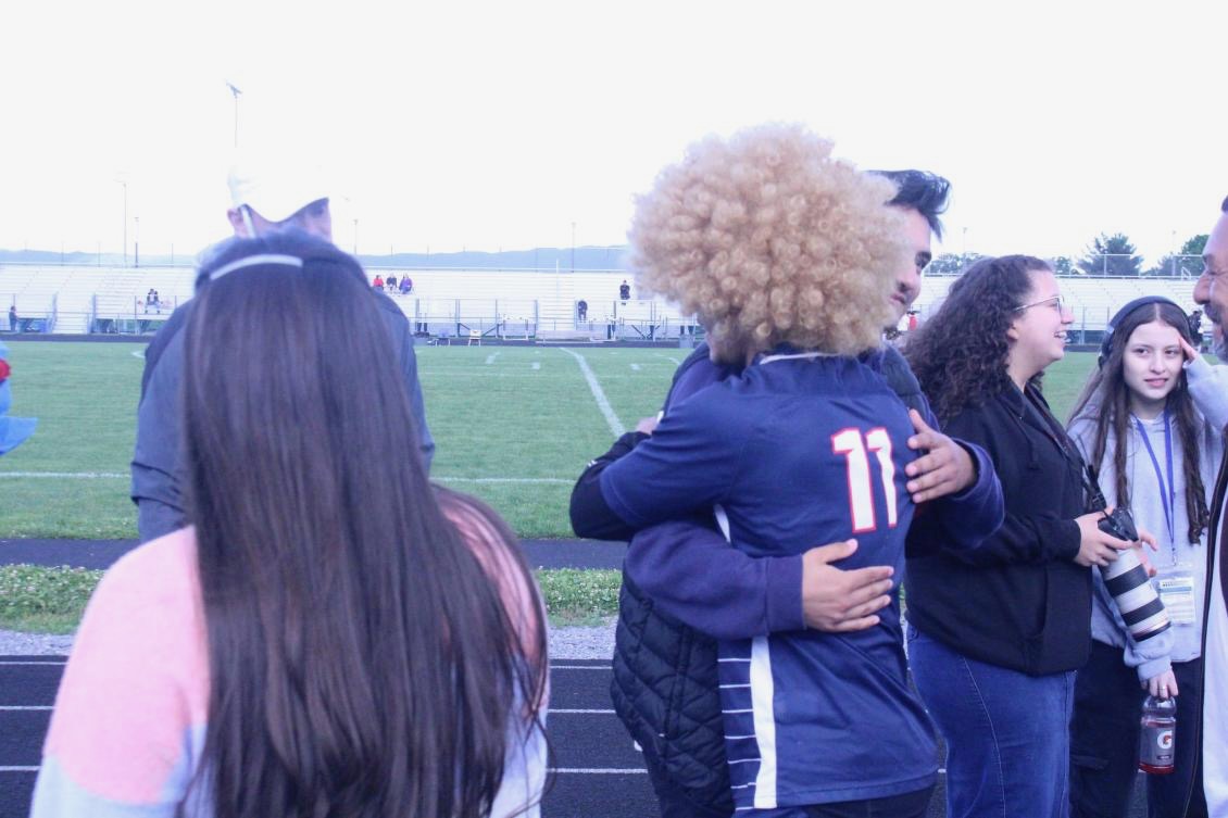 Senior Izaack Cruz celebrate with a hug.