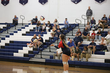 Junior Jordan Byler serves the ball to the Knights of Turner Ashby