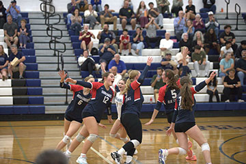 The Blue Streaks celebrate as they secure a point against the Knights.