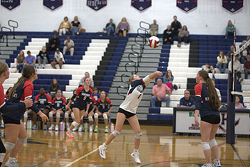 Junior Finnly Miller hits the ball up toward the net.