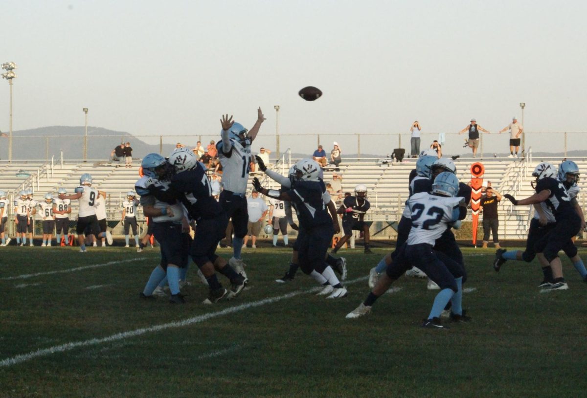 Both teams try for the ball.