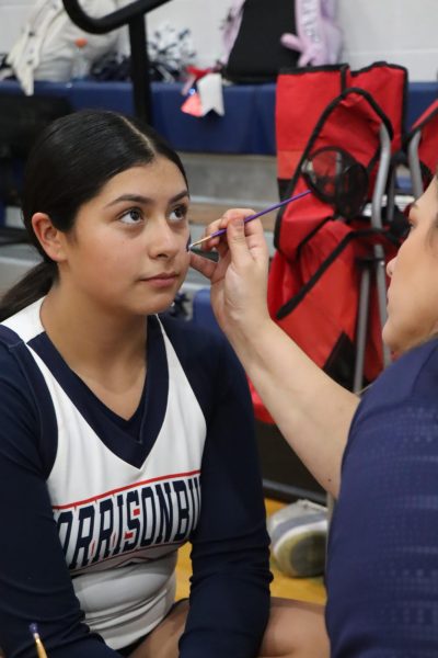 Freshman Lili Cruz getting her face painted before the game.