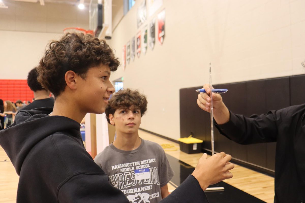 Freshman Joel Metzler tests his reaction time at a booth at the STEMinar.