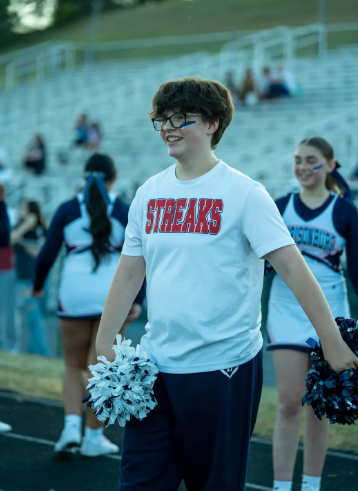 Freshman Lyd Brett cheering for The JV sideline team.